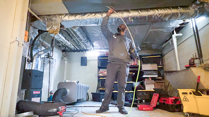 The Real Cost of Air Duct Cleaning in Milwaukee 1 air duct cleaner in milwaukee going over costs.