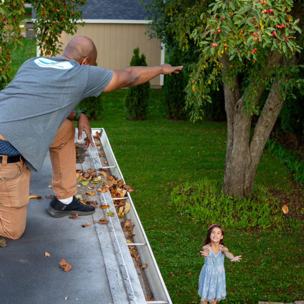 Totally Clean owner is removing leaves from gutters in Brookfield, WI.