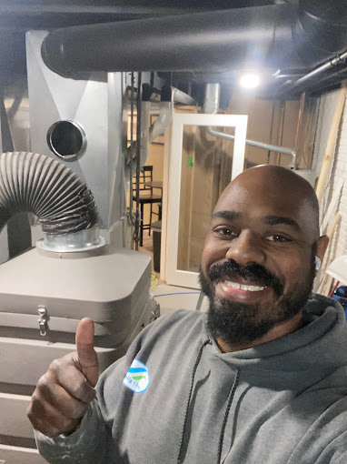 James Green, owner of Totally Clean standing next to his duct cleaning vacuum in Brookfield, WI.