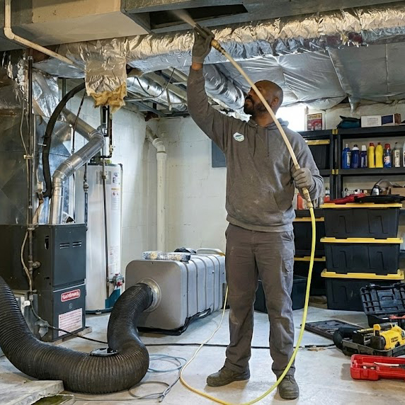 james green cleaning air ducts in a residential homes basement in milwaukee.